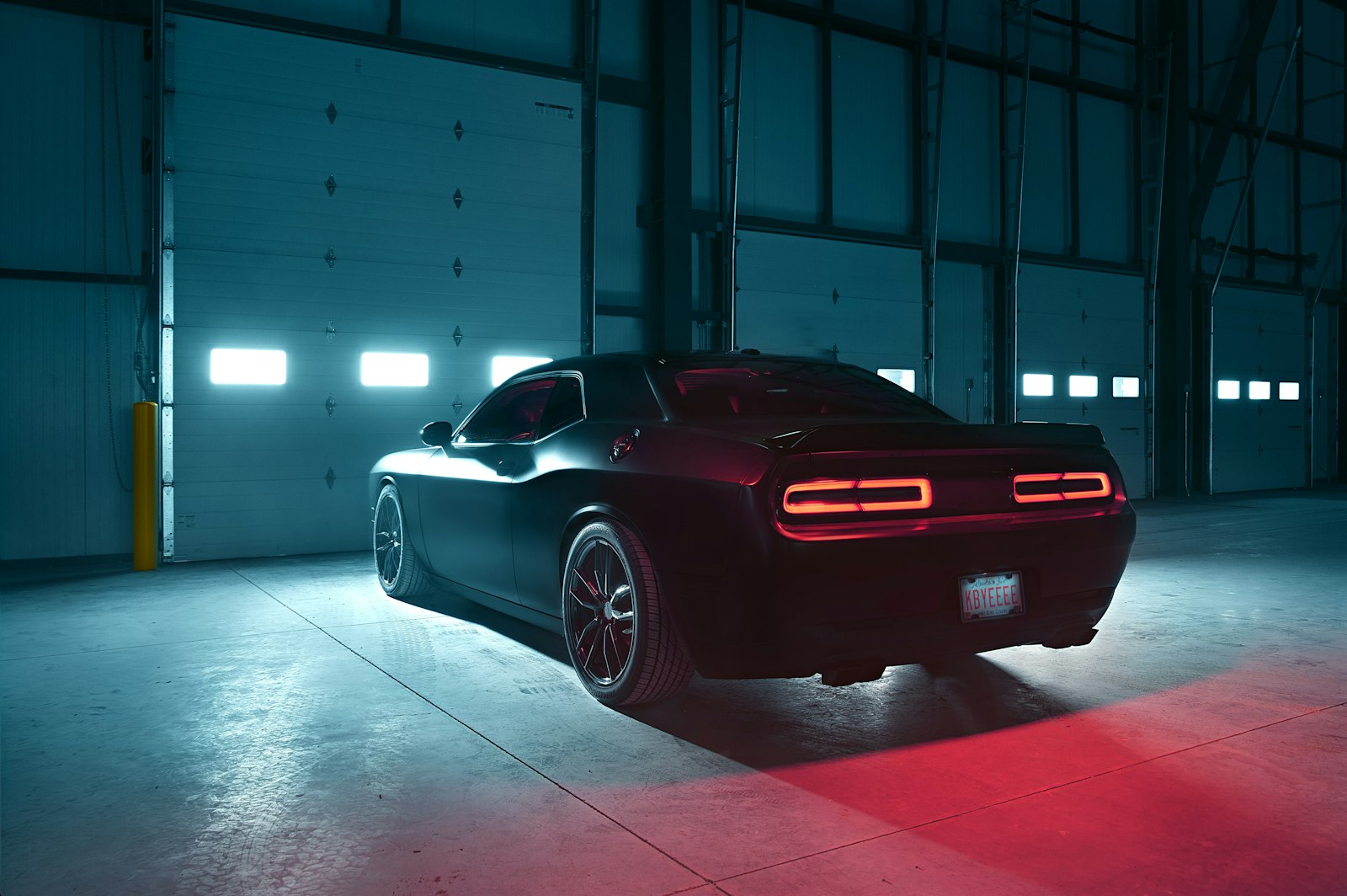 Black muscle car under studio light